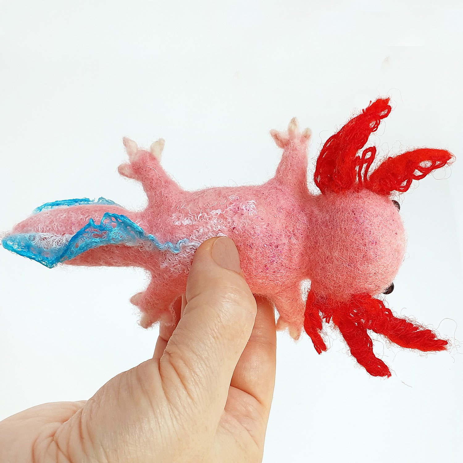 Cute pink plush axolotl. Soft toy plushie axolotl