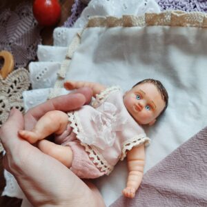Little reborn boy in vintage clothes, handmade doll