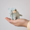 blue plush miniature elephant on palm