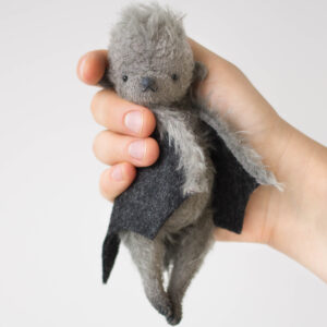 gray fluffy bat doll black wings in the cam