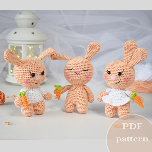 3 cute crocheted rabbits - boy, girl, sleeping. Everyone has a little carrot.