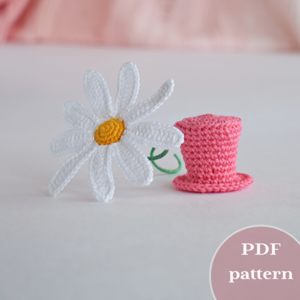 Un chapeau haut de forme pour un jouet et une marguerite. Crocheté.