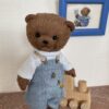 Brown teddy bear with blue clothing. Size 4.7 inches