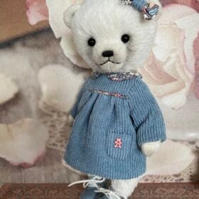 White teddy bear in blue dress. Cute teddy bear plush handmade
