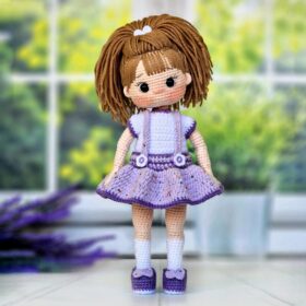 Gentle cute doll in lilac clothes and with beautiful hair