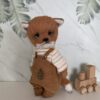 Cute red teddy fox. Miniature teddy friend in red clothes.