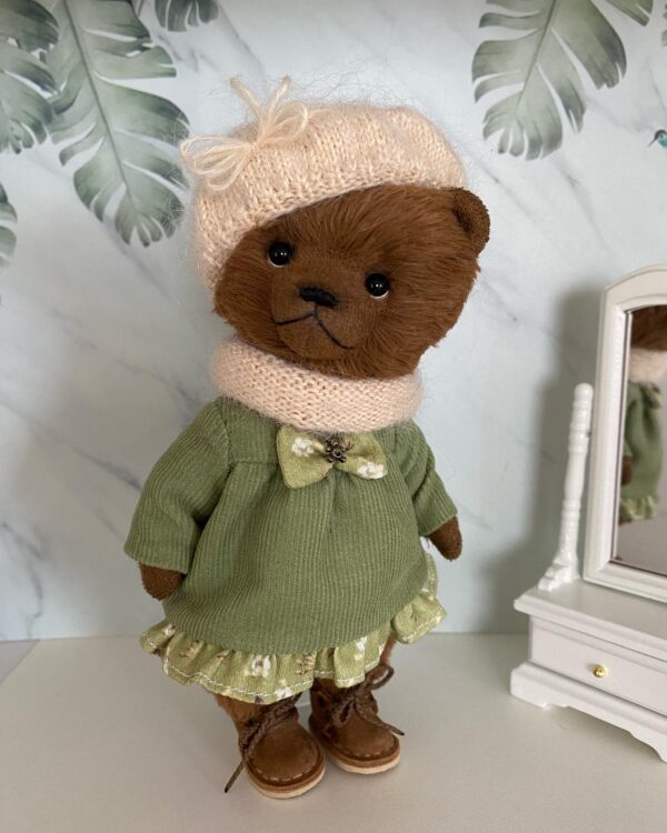 Brown teddy bear girl. Cute teddy bear in a green dress.