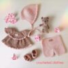 A SET OF CROCHETED CLOTHES FOR A DOLL