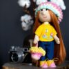 Bright handmade doll girl with embroidery.
