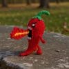Plush crochet crazy red hot pepper amigurumi toy, handmade funny vegetable pattern.