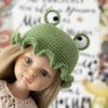 Paola Reina doll in a funny knitted frog hat