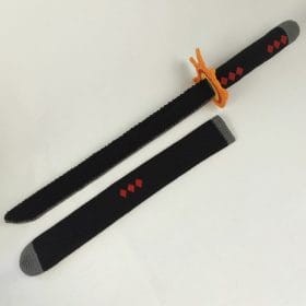 A handmade crochet replica of Tanjiro Kamado’s katana from the anime Demon Slayer. The sword features a black blade with red diamond accents, a detailed orange flame-shaped guard, and a matching black sheath with gray tips. A soft, safe, and stylish amigurumi cosplay weapon.