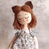 handmade textile doll girl with cat ears and tail closed eyes decorated with embroidery