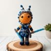 Crochet pattern of Ahsoka Tano amigurumi doll from Star Wars. Handmade toy with blue and white montrals and orange skin.