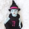 13 inch doll dressed in handmade Halloween witch costume with knit dress