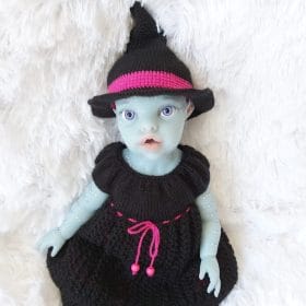 13 inch doll dressed in handmade Halloween witch costume with knit dress
