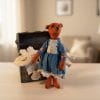 Vintage teddy bear with clothes.